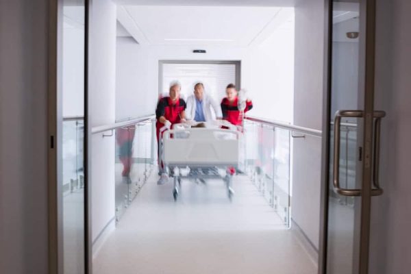 doctors-pushing-emergency-stretcher-bed-corridor